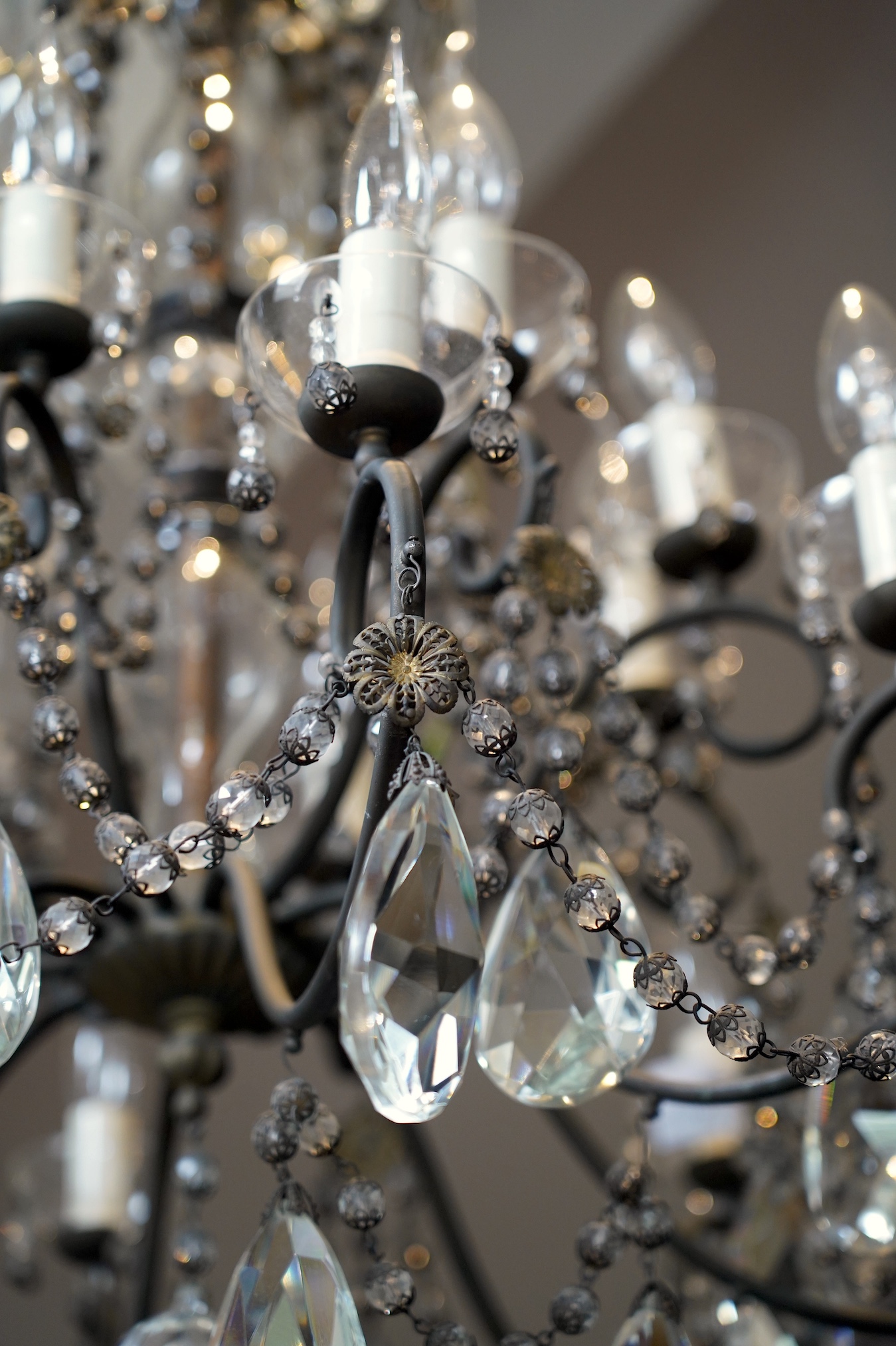 A two tier chandelier with eight branches on each tier, together with a pair of three branch wall lights, chandelier approximately 73cm high